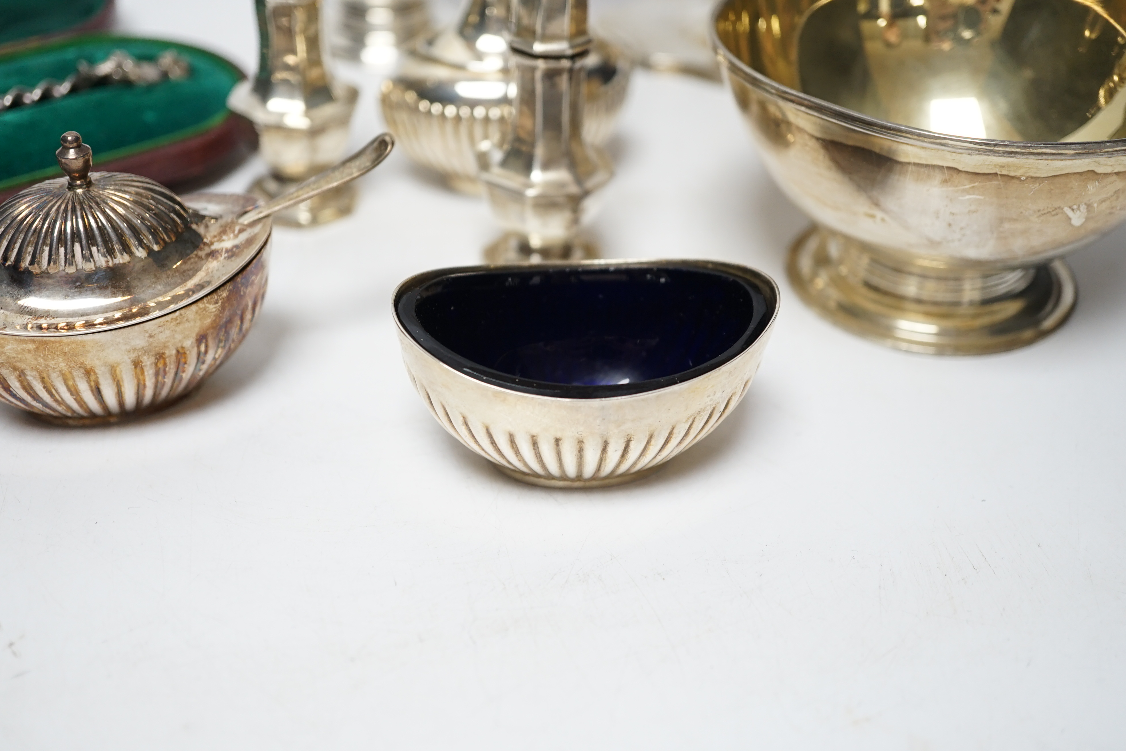 A group of small silver including Edwardian silver oval sugar basket, a modern silver cream jug and sugar bowl, five assorted condiments, a silver sifter spoon and a late Victorian scent bottle, 56mm.